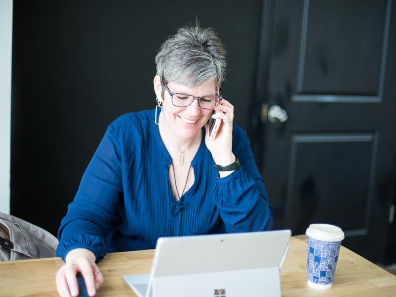 Woman sitting networking at her desk